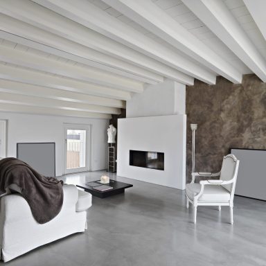 fireplace and modern leather sofa and armchair in the modern penthouse with concrete floor